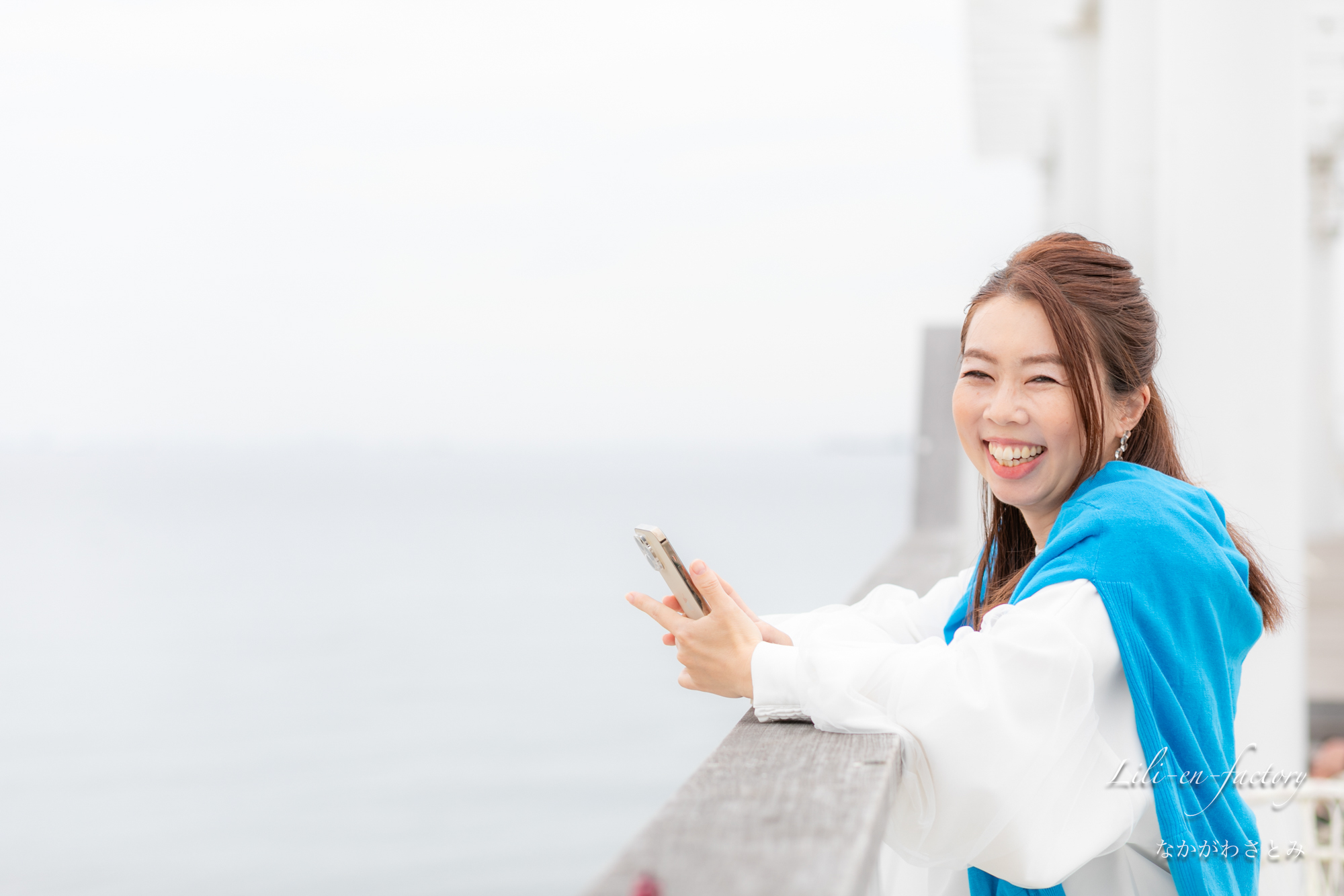 海岸でスマホを見る女性起業家